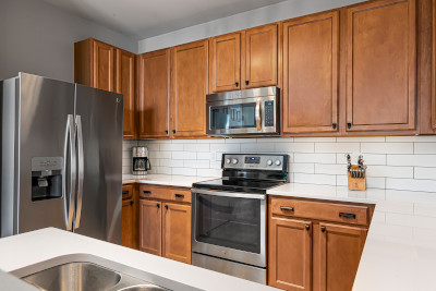 kitchen with large capacity refrigerator, ceramic stove top, and electric oven